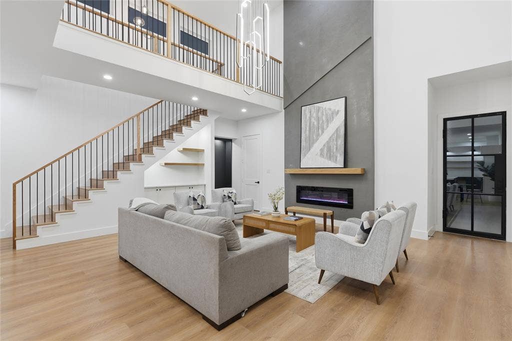 2212 Marburg Street, Dallas, TX 75215 Double-height living space featuring wood-finish flooring and a contemporary linear fireplace