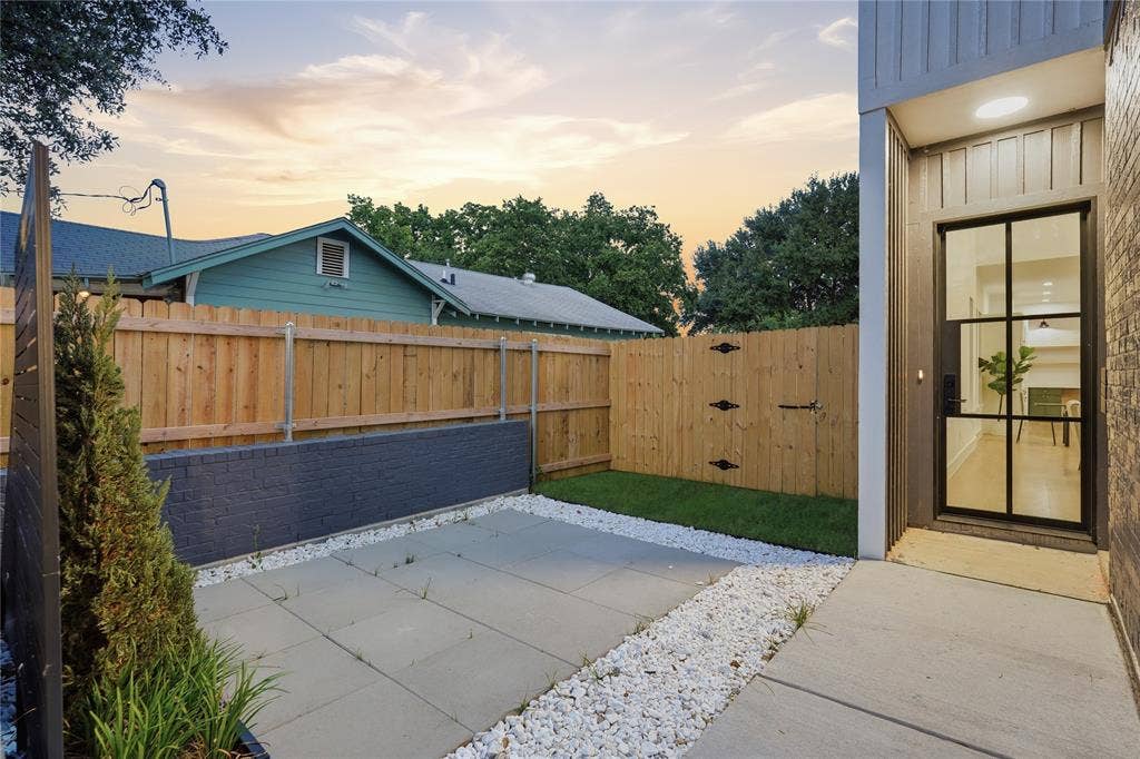 2212 Marburg Street, Dallas, TX 75215 Modern entry door with black grid design, featuring a concrete pathway and white decorative gravel