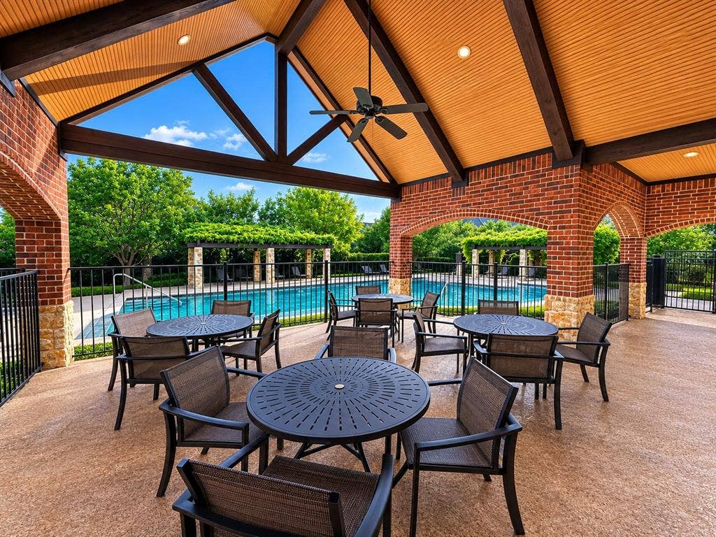 7424 Mitchell Drive, McKinney, TX 75070 Covered outdoor patio area featuring brick arches and stone accents
