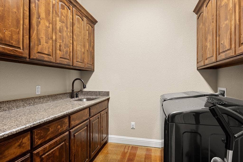 104 Rattling Antler Court, Azle, TX 76020 Large laundry room with ample cabinet storage and hanging space.