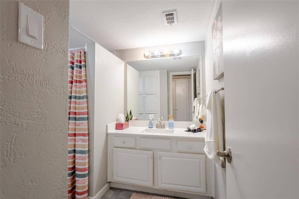 15221 Berry Trail, #1201, Dallas, TX 75248 White vanity with dual lower cabinets and three drawers