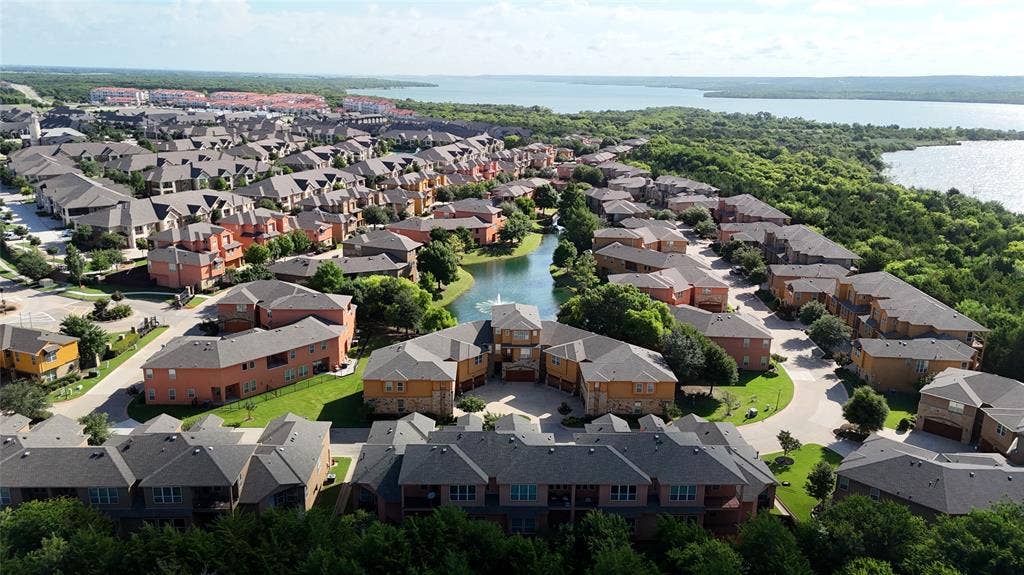 7310 Venice Drive, #4, Grand Prairie, TX 75054 Expansive community with a central pond featuring a water fountain, surrounded by varied architectural styles