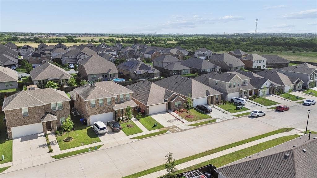 317 Fire Rock Drive, Royse City, TX 75189 Residential neighborhood featuring a consistent architectural style, brick and siding exteriors, attached garages, and paved driveways