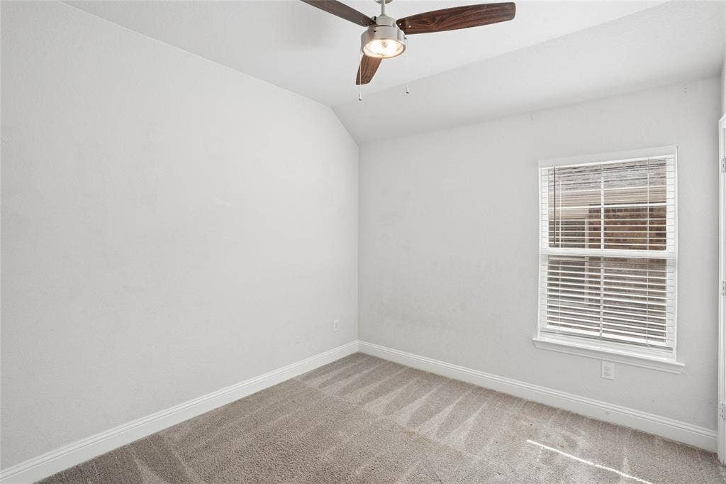 317 Fire Rock Drive, Royse City, TX 75189 Neutral wall paint, plush carpet flooring, and a ceiling fan with integrated lighting