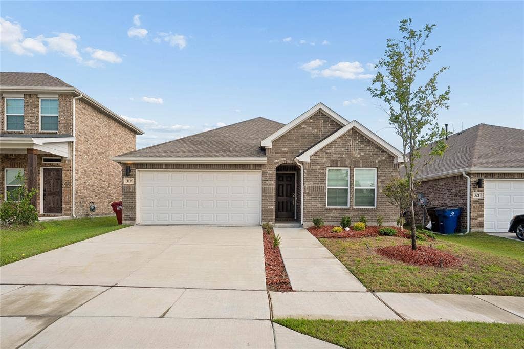 317 Fire Rock Drive, Royse City, TX 75189 Single-story brick exterior with an attached two-car garage
