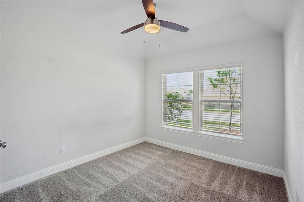 317 Fire Rock Drive, Royse City, TX 75189 Room featuring light-toned carpeting, white walls, and a ceiling fan with integrated lighting