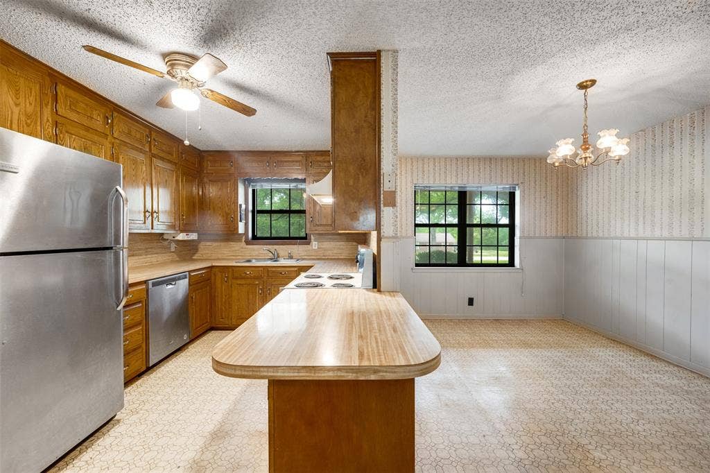 8798 Hill N Dale Road, Tyler, TX 75709 Kitchen featuring ample wood cabinetry, stainless steel refrigerator and dishwasher, and a built-in electric stovetop