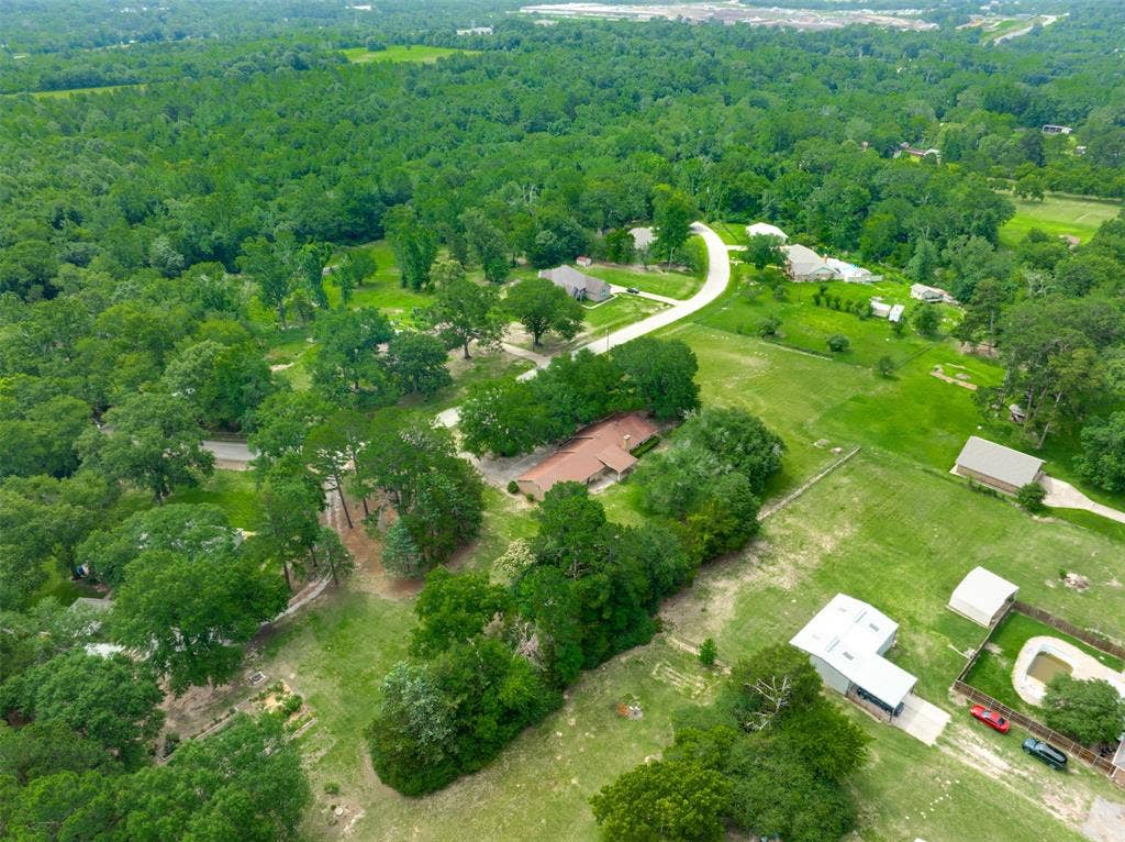 8798 Hill N Dale Road, Tyler, TX 75709 Expansive rural setting featuring a winding paved road, multiple residential properties, dense tree lines, and open green spaces
