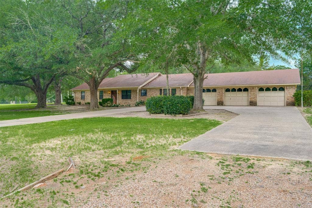 8798 Hill N Dale Road, Tyler, TX 75709 Brick exterior with a brown roof and a three-car garage