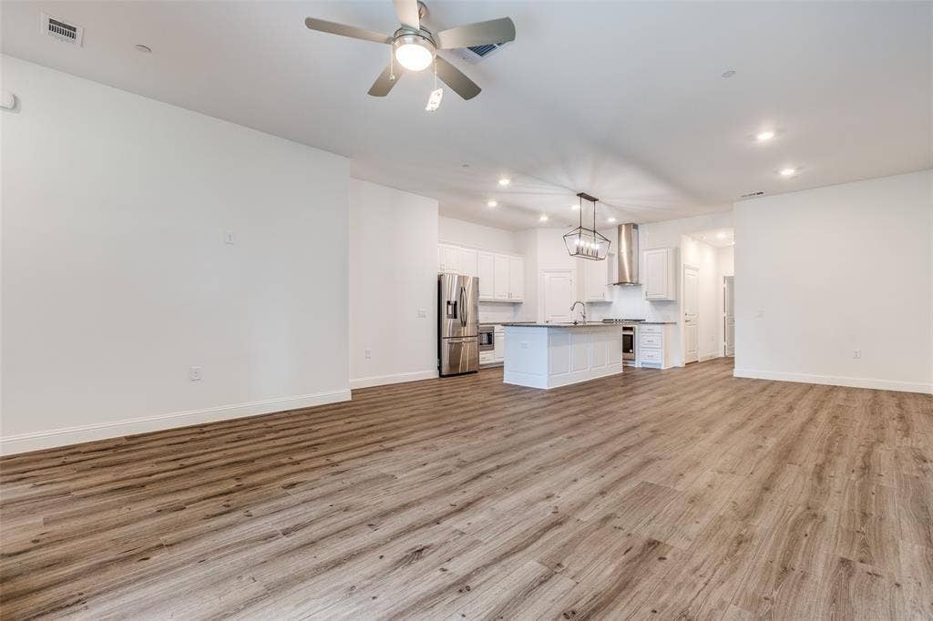 3930 Dalea Drive, Prosper, TX 75078 Open-concept living area featuring wood-finish flooring, recessed lighting, and a ceiling fan