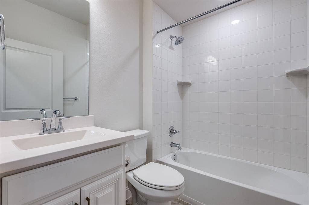 3930 Dalea Drive, Prosper, TX 75078 2nd full Bathroom featuring a white vanity with an integrated sink, chrome faucet, and a large mirror