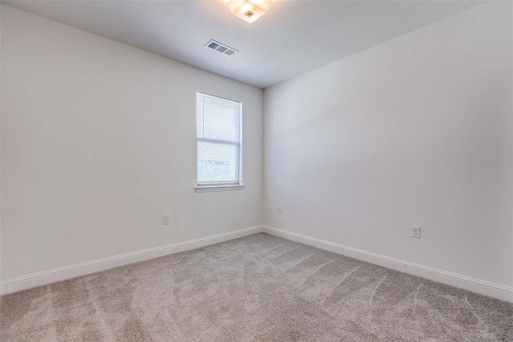 3930 Dalea Drive, Prosper, TX 75078 Bedroom 2 Neutral-toned interior room featuring light gray carpeting, white walls, and a window with blinds
