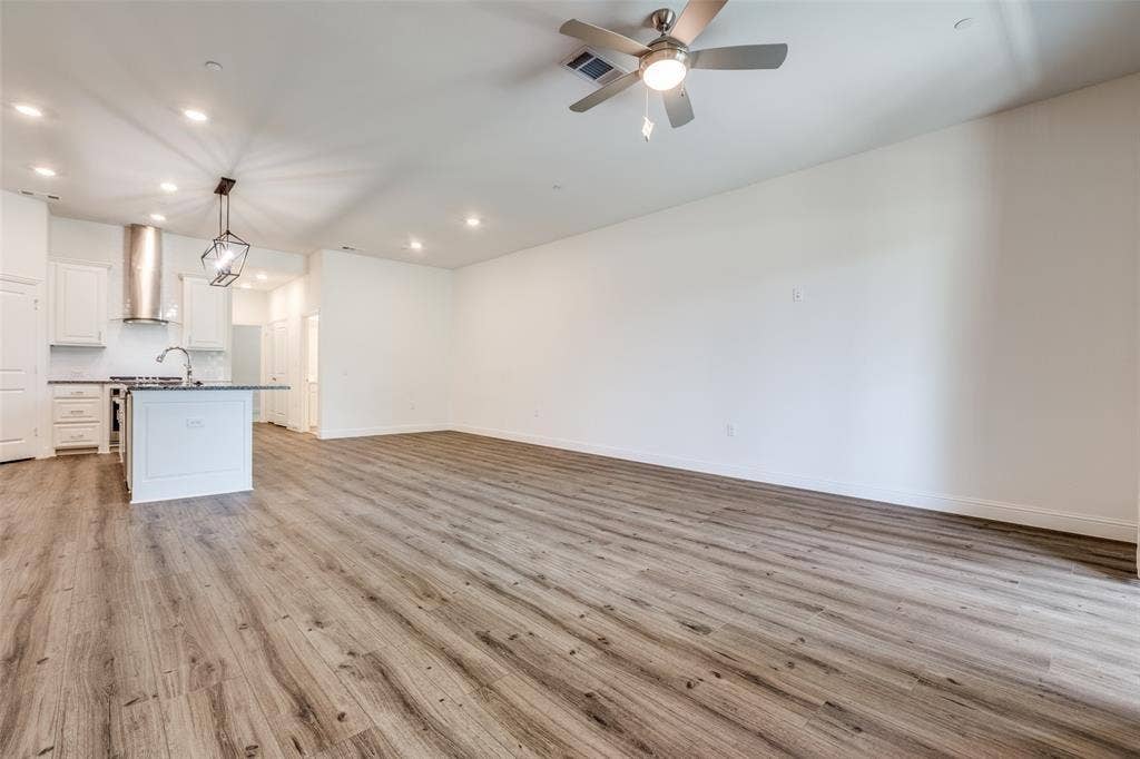3930 Dalea Drive, Prosper, TX 75078 Open-concept living area/dining area with wood-finish flooring, recessed lighting, and a ceiling fan