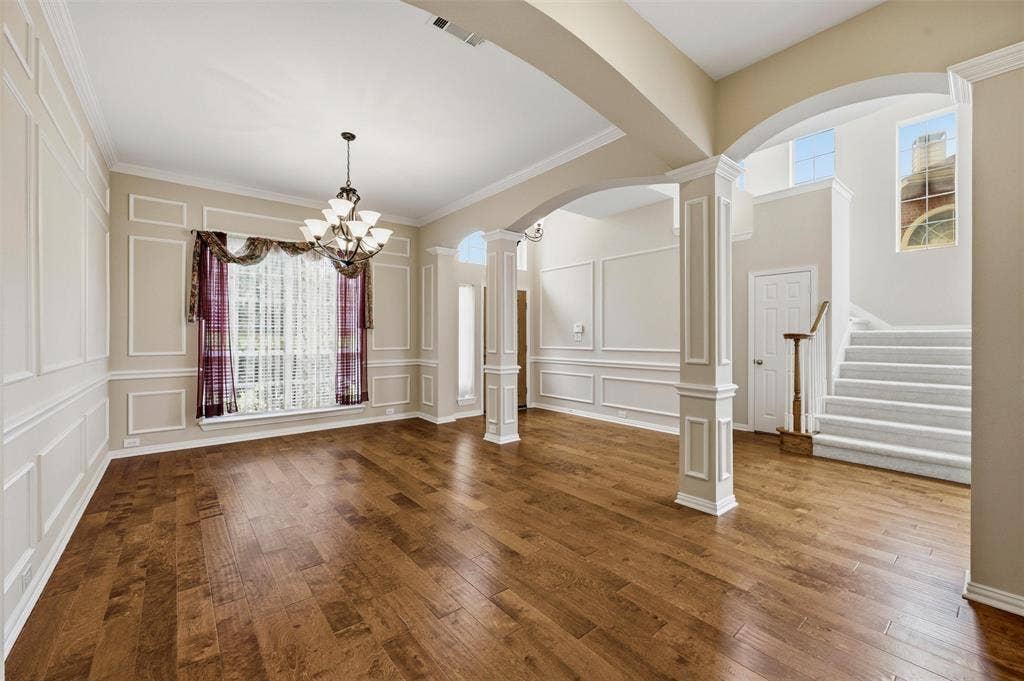 2228 Amy Lane, Plano, TX 75074 Beautirul columns enhance the dining room and the entry - view of coat closet next to steps - 1/2 bath also in that area -
