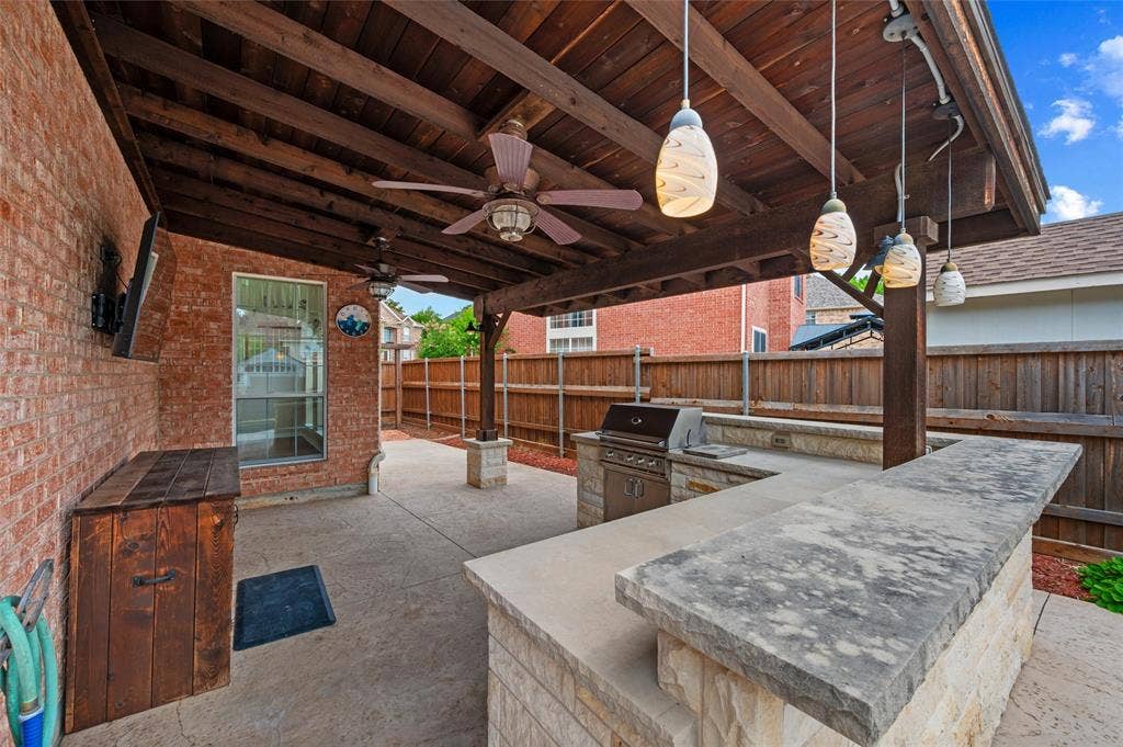 2228 Amy Lane, Plano, TX 75074 Back Patio PENDNT LIGHTING = BOARD ON BOARD PRIVACY FENCING - ADDITIONAL STORAGE UNDER MOUNTED TV