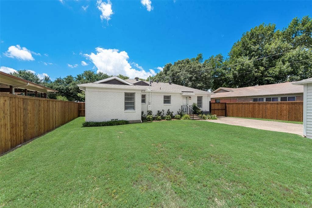 2523 San Medina Avenue, Dallas, TX 75228 Expansive grass lawn bordered by a wood privacy fence