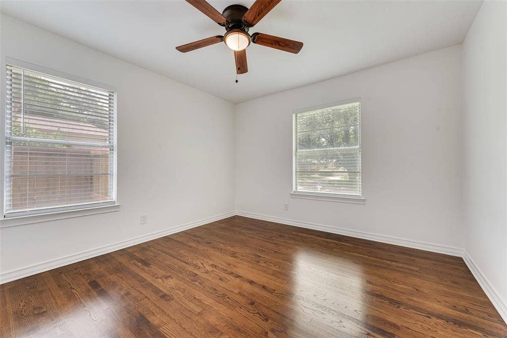 2523 San Medina Avenue, Dallas, TX 75228 Room featuring rich wood-finish flooring, crisp white walls, and a ceiling fan with integrated lighting