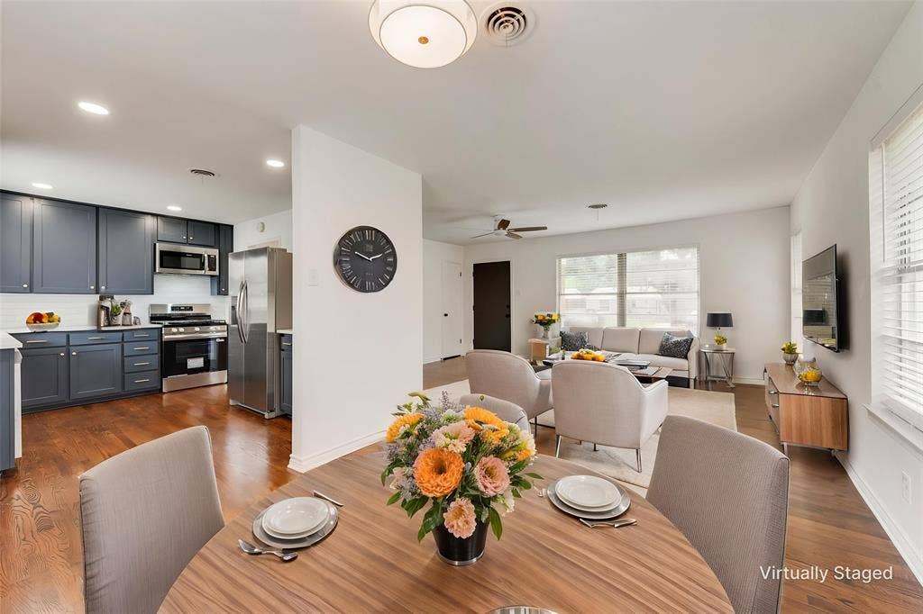 2523 San Medina Avenue, Dallas, TX 75228 Open concept living area featuring wood-finish flooring, recessed lighting, and a kitchen with dark cabinetry and stainless steel appliances