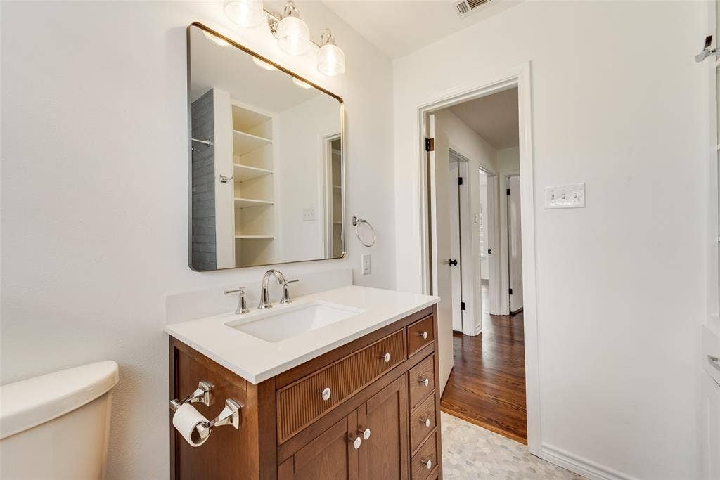2523 San Medina Avenue, Dallas, TX 75228 Bathroom vanity with a white countertop, undermount sink, and chrome fixtures