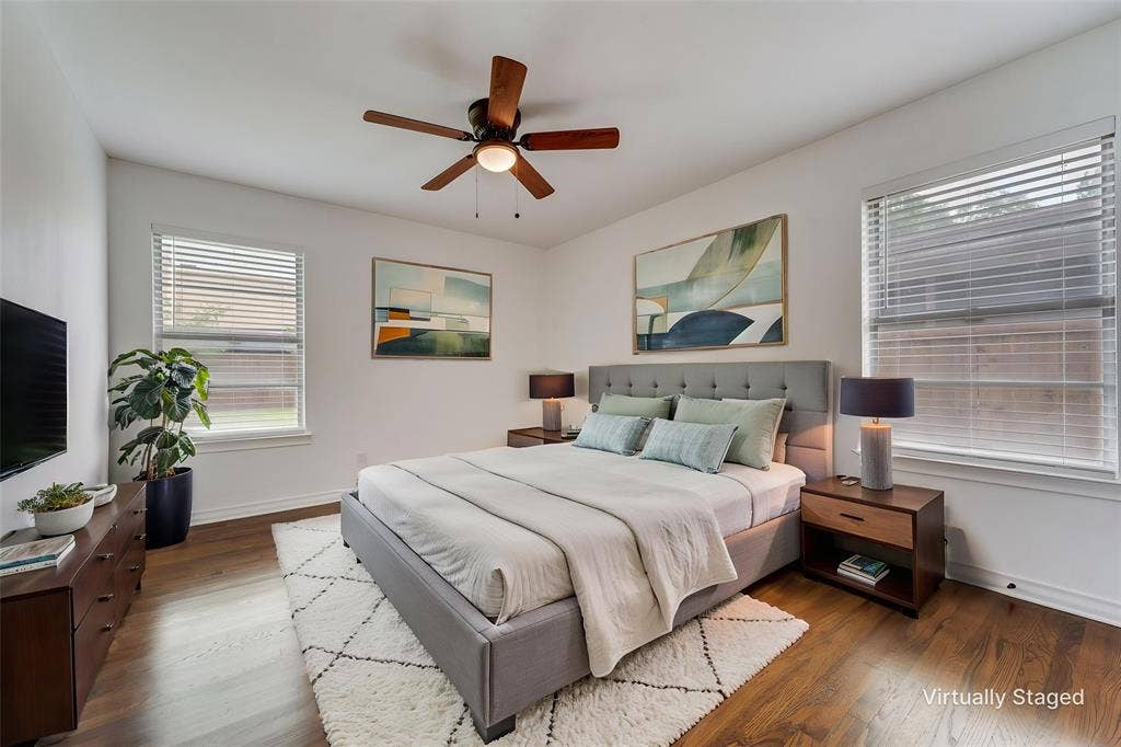 2523 San Medina Avenue, Dallas, TX 75228 Bedroom featuring wood-finish flooring, white walls, and two windows with blinds