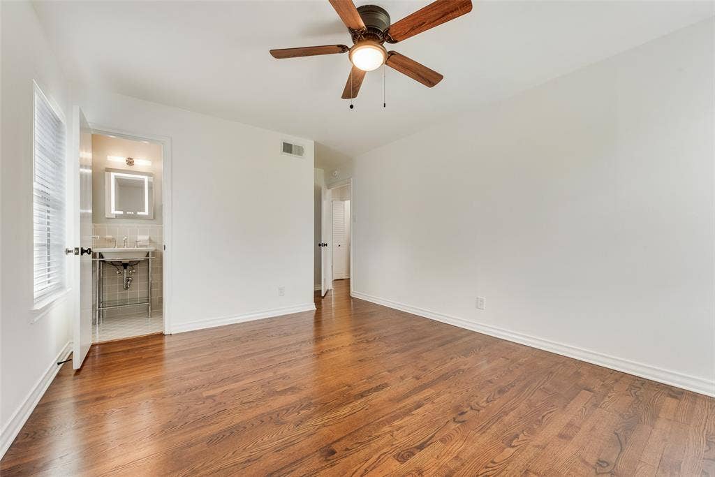 2523 San Medina Avenue, Dallas, TX 75228 Spacious interior featuring rich wood flooring, crisp white walls, and a ceiling fan with integrated lighting