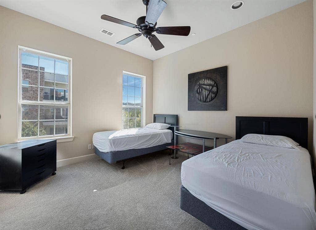 5001 Meridian Lane, #2103, Addison, TX 75001 Light-filled room featuring two double-hung windows, a ceiling fan with integrated lighting, recessed lighting, and neutral-toned wall paint