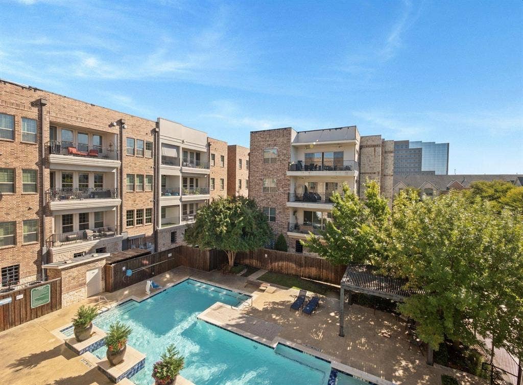 5001 Meridian Lane, #2103, Addison, TX 75001 Courtyard swimming pool with surrounding paver decking, mature trees, and privacy fencing