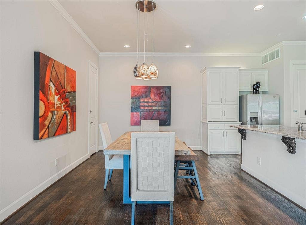 5001 Meridian Lane, #2103, Addison, TX 75001 Dining area featuring rich wood-finish flooring, white crown molding, recessed lighting, and a multi-pendant light fixture