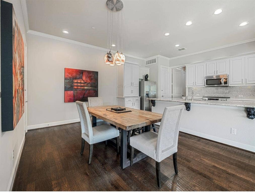5001 Meridian Lane, #2103, Addison, TX 75001 Open-concept dining area featuring dark wood-finish flooring, recessed lighting, and crown molding