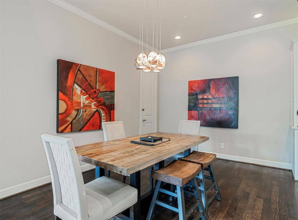 5001 Meridian Lane, #2103, Addison, TX 75001 Dining area featuring dark wood-finish flooring, light gray walls, and white crown molding