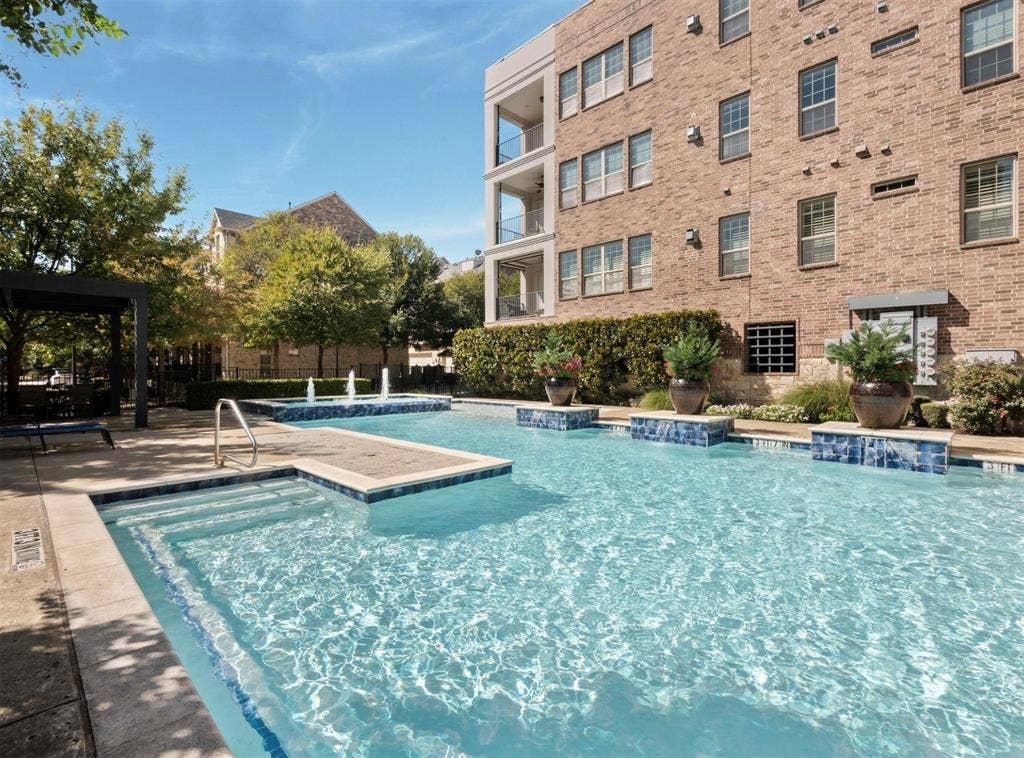 5001 Meridian Lane, #2103, Addison, TX 75001 Outdoor swimming pool featuring a tiled spa, integrated fountains, and surrounding hardscaping