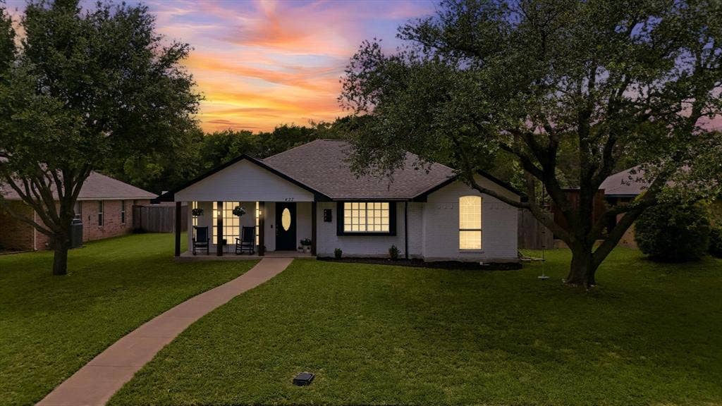 437 Bradshaw Street, Cedar Hill, TX 75104 White single-story residence with a dark-trimmed gable roof