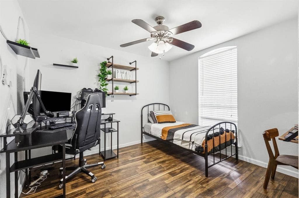 437 Bradshaw Street, Cedar Hill, TX 75104 Room featuring wood-finish flooring, a ceiling fan with integrated lighting, and a window with horizontal blinds