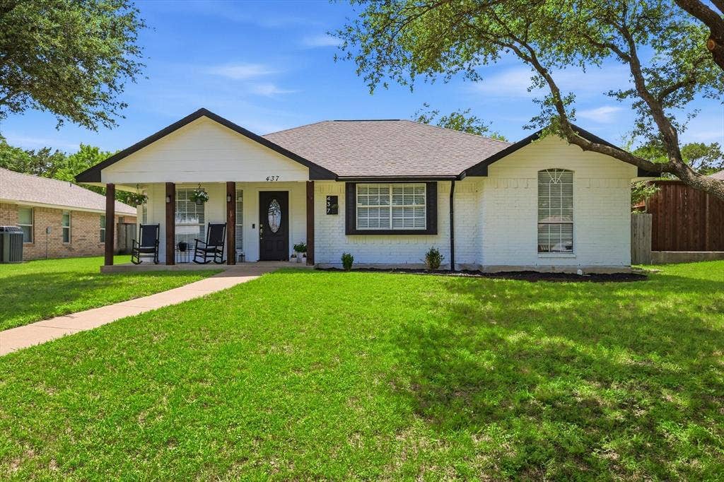 437 Bradshaw Street, Cedar Hill, TX 75104 Exterior featuring a white brick facade, dark trim, and a covered porch supported by wood-finish columns