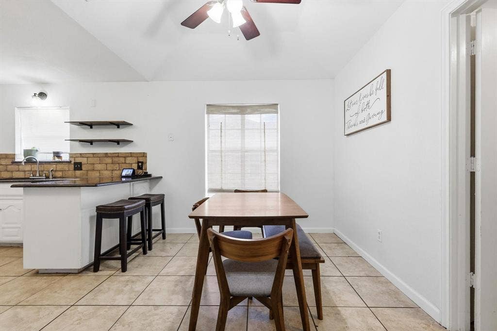 437 Bradshaw Street, Cedar Hill, TX 75104 Open-concept kitchen and dining area featuring vaulted ceilings, a ceiling fan with integrated lighting, and tile flooring