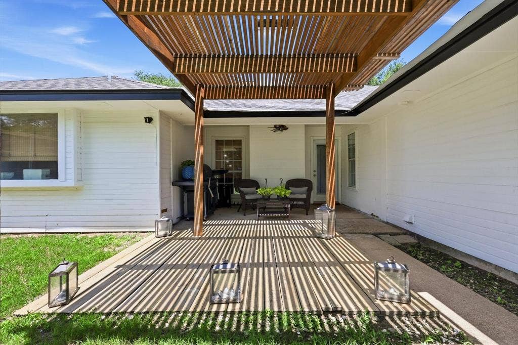 437 Bradshaw Street, Cedar Hill, TX 75104 Wood slat pergola providing shade to an outdoor patio with concrete and wood-finish decking