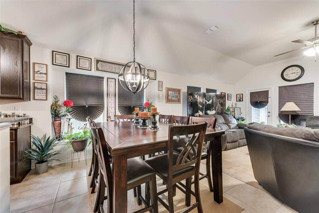 301 Billy Wickliffe Drive, Wilmer, TX 75172 Spacious dining area featuring a vaulted ceiling and tile flooring, opening to a living room with carpeted flooring
