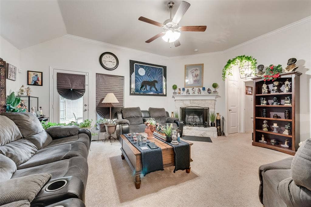 301 Billy Wickliffe Drive, Wilmer, TX 75172 Spacious living area featuring a vaulted ceiling with a ceiling fan, crown molding, and neutral carpet flooring