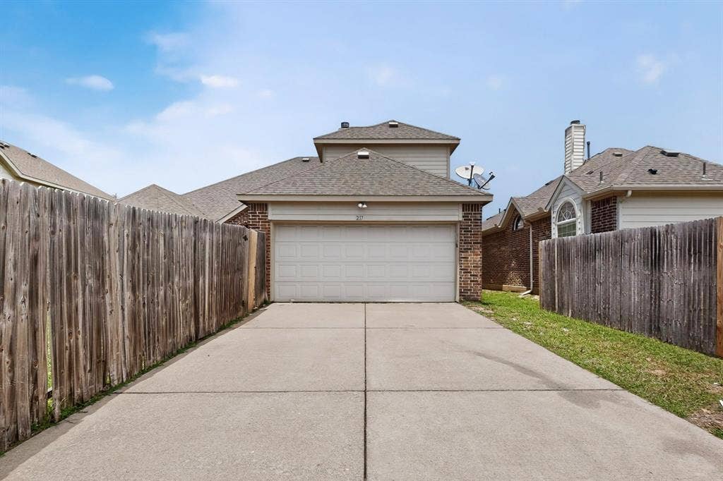 217 Gatehouse Drive, Red Oak, TX 75154 Concrete driveway extending to a two-story residence with brick and siding exterior