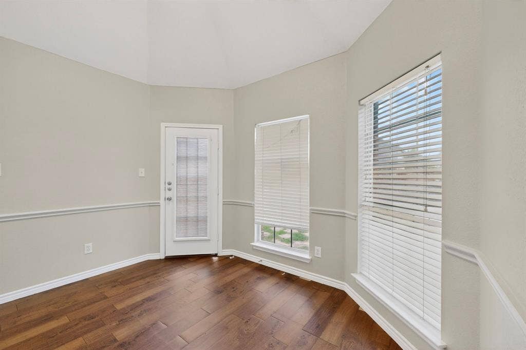 217 Gatehouse Drive, Red Oak, TX 75154 The breakfast are has large windows with views and access to the backyard.