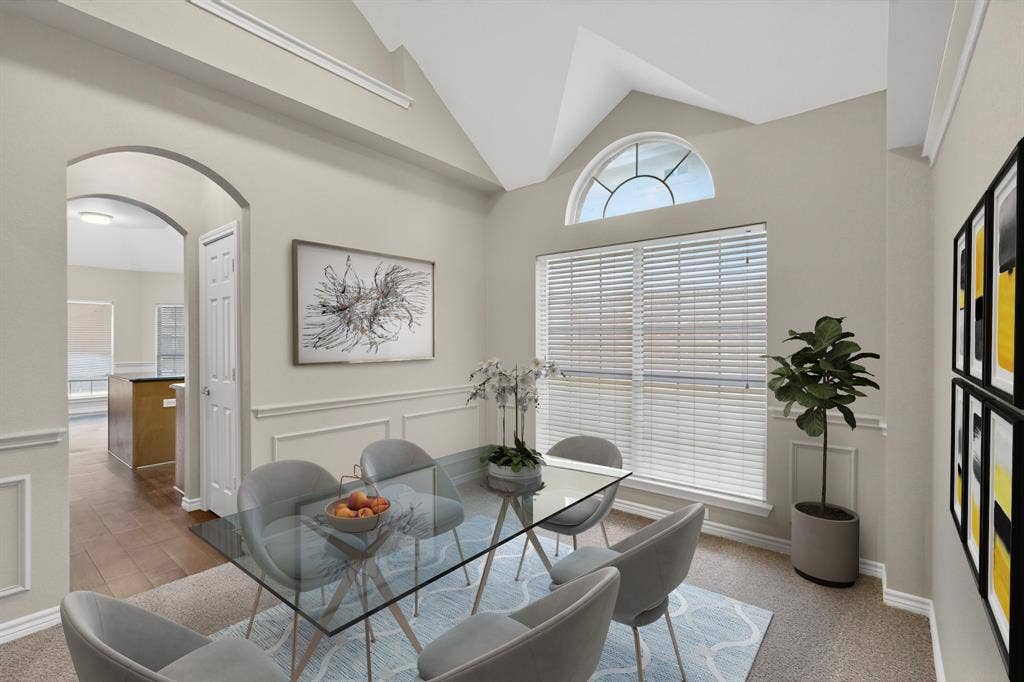 217 Gatehouse Drive, Red Oak, TX 75154 Vaulted ceiling with an arched transom window above a large rectangular window, complemented by wainscoting and crown molding details