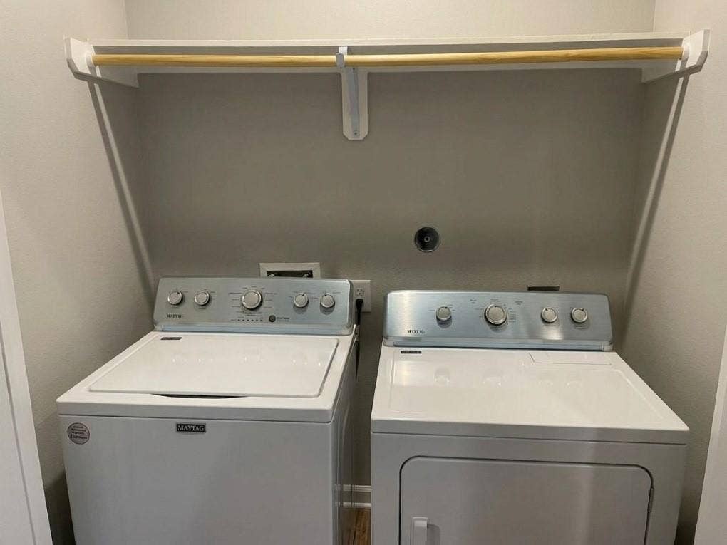 9114 Caddo Road, #A & B, Houston, TX 77078 Dedicated laundry area featuring a white washing machine, white dryer, and an overhead drying rod