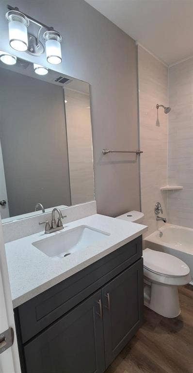 9114 Caddo Road, #A & B, Houston, TX 77078 Bathroom 1 - featuring a dark gray vanity with a light countertop, an integrated sink, and a brushed nickel faucet