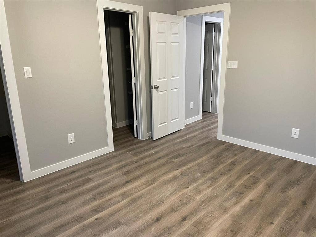 9114 Caddo Road, #A & B, Houston, TX 77078 Neutral-toned interior featuring vinyl flooring, light gray walls, white trim, and a white paneled door