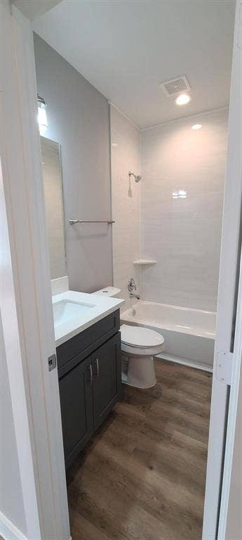 9114 Caddo Road, #A & B, Houston, TX 77078 Bathroom 2 - Contemporary bathroom featuring a modern vanity with a white countertop and dark gray cabinetry, a white toilet, and a bathtub with white subway tile surround