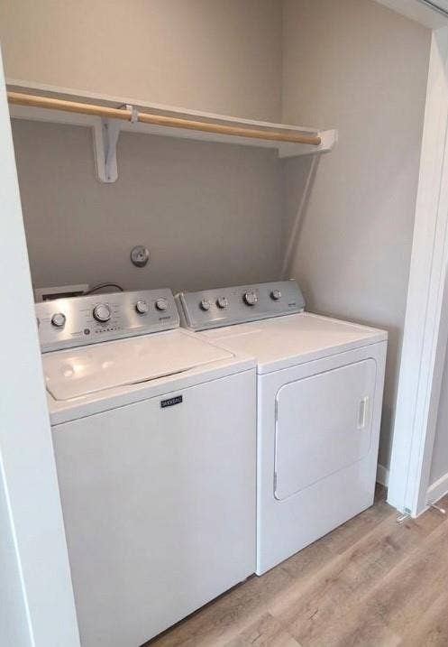9114 Caddo Road, #A & B, Houston, TX 77078 Dedicated laundry area with a top-load washing machine, front-load dryer, built-in shelving, and wood-finish flooring