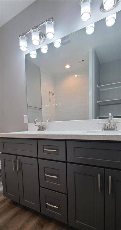 9114 Caddo Road, #A & B, Houston, TX 77078 Bathroom 3 - Double vanity featuring dark cabinetry with brushed nickel hardware and a light-toned countertop