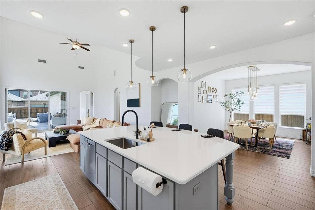 1205 Shady Fox Way, Arlington, TX 76005 Kitchen island with white countertop, integrated sink, and gray cabinetry