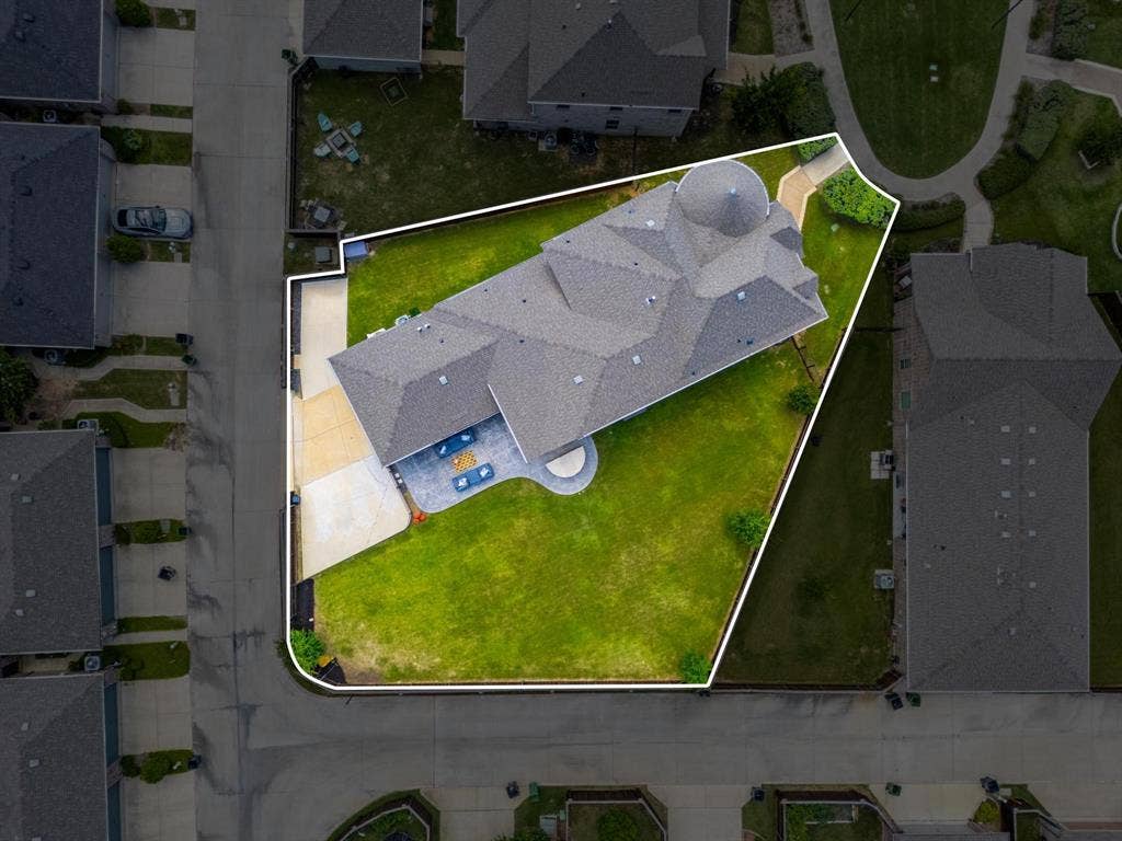 1205 Shady Fox Way, Arlington, TX 76005 Spacious property featuring a large landscaped lawn, an expansive paved patio, and a driveway