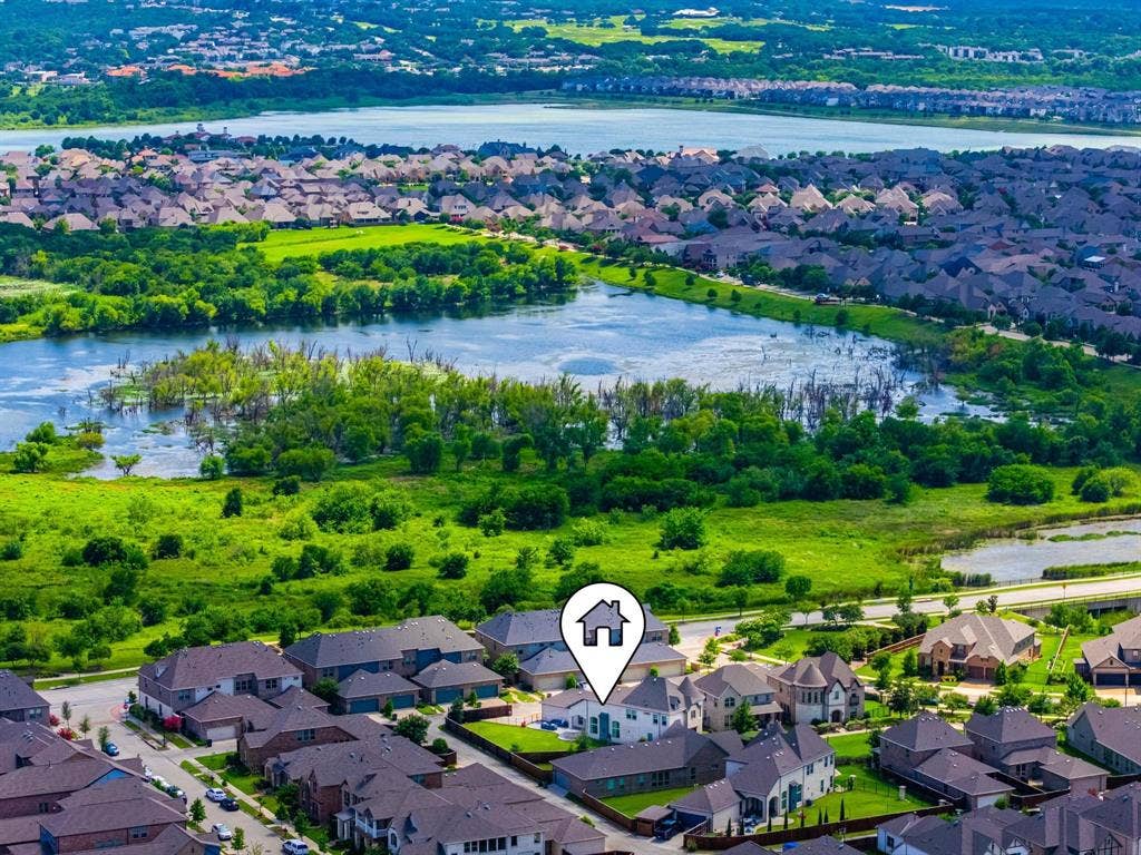 1205 Shady Fox Way, Arlington, TX 76005 Aerial perspective of a residential neighborhood with varied architectural styles, featuring properties with dark-toned roofs and mature landscaping